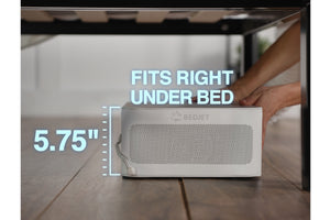 A closeup of hands placing a BedJet under a bedframe and the words "Fits right under bed, 5.75 inches"