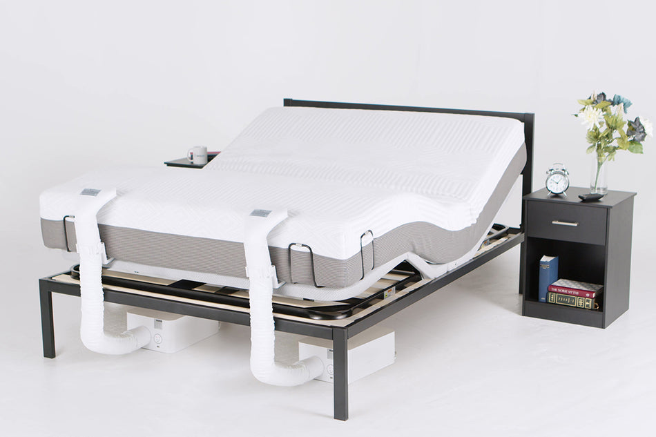 A Queen bedframe with a PowerLayer installed and a bare mattress on top, and two BedJet units are installed at the foot of the bed with the footside of the PowerLayer raised