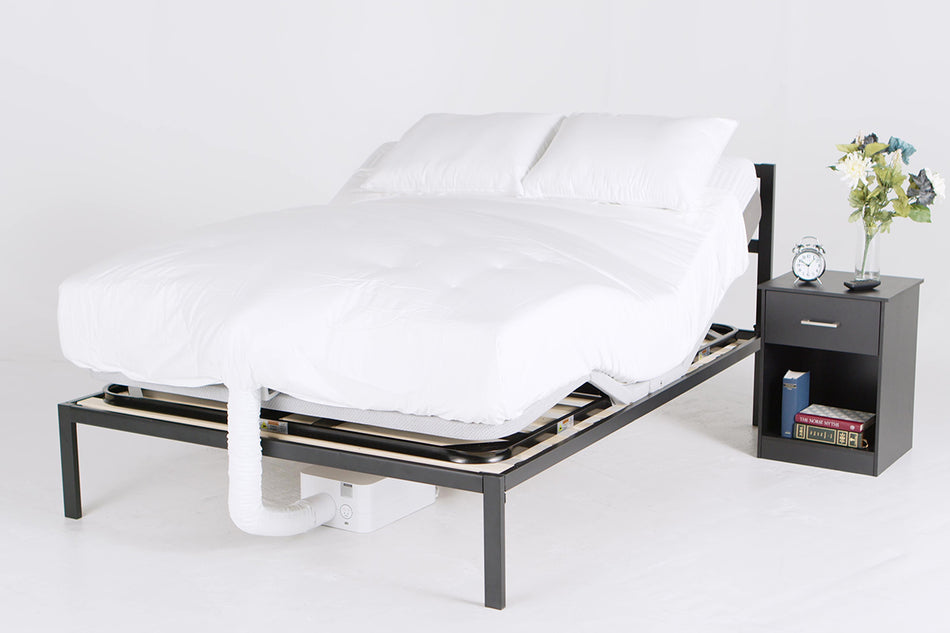 A queen bedframe with a PowerLayer adjustable frame installed and the foot/head sides raised, a BedJet is installed at the foot of the bed with a Cloud Sheet over the mattress that is inflated with cooling air