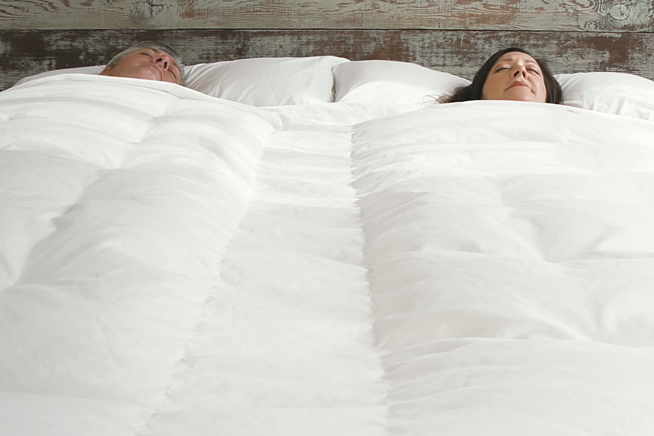 a couple sleeping peacefully in bed under a Cloud Sheet