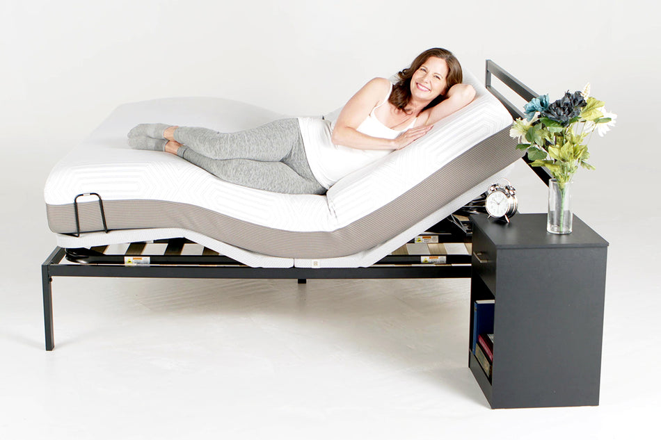 a brunette woman reclining on a bed with a PowerLayer installed and the head and foot sides raised